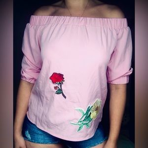 Off the shoulder loose fit pink top with flower patches and casual look